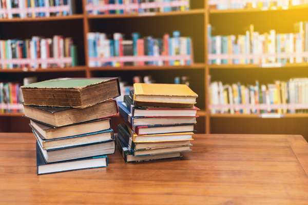 Stack of books and a calm reading setup on a simple table